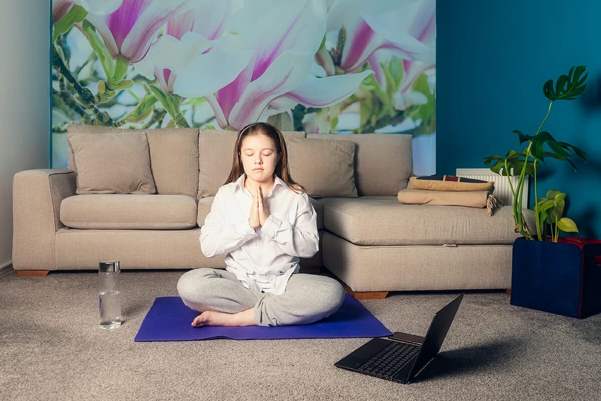 teenager-girl-is-doing-online-yoga-with-laptop-during-self-isolation-at-her-living-room-no-equipment_t20_rLxZ7d Live Streaming by Cadence Studios | Event Production & Marketing in Sherman, TX